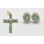 A pair of 9ct gold ladies emerald and diamond cluster earrings having oval cut emeralds having a