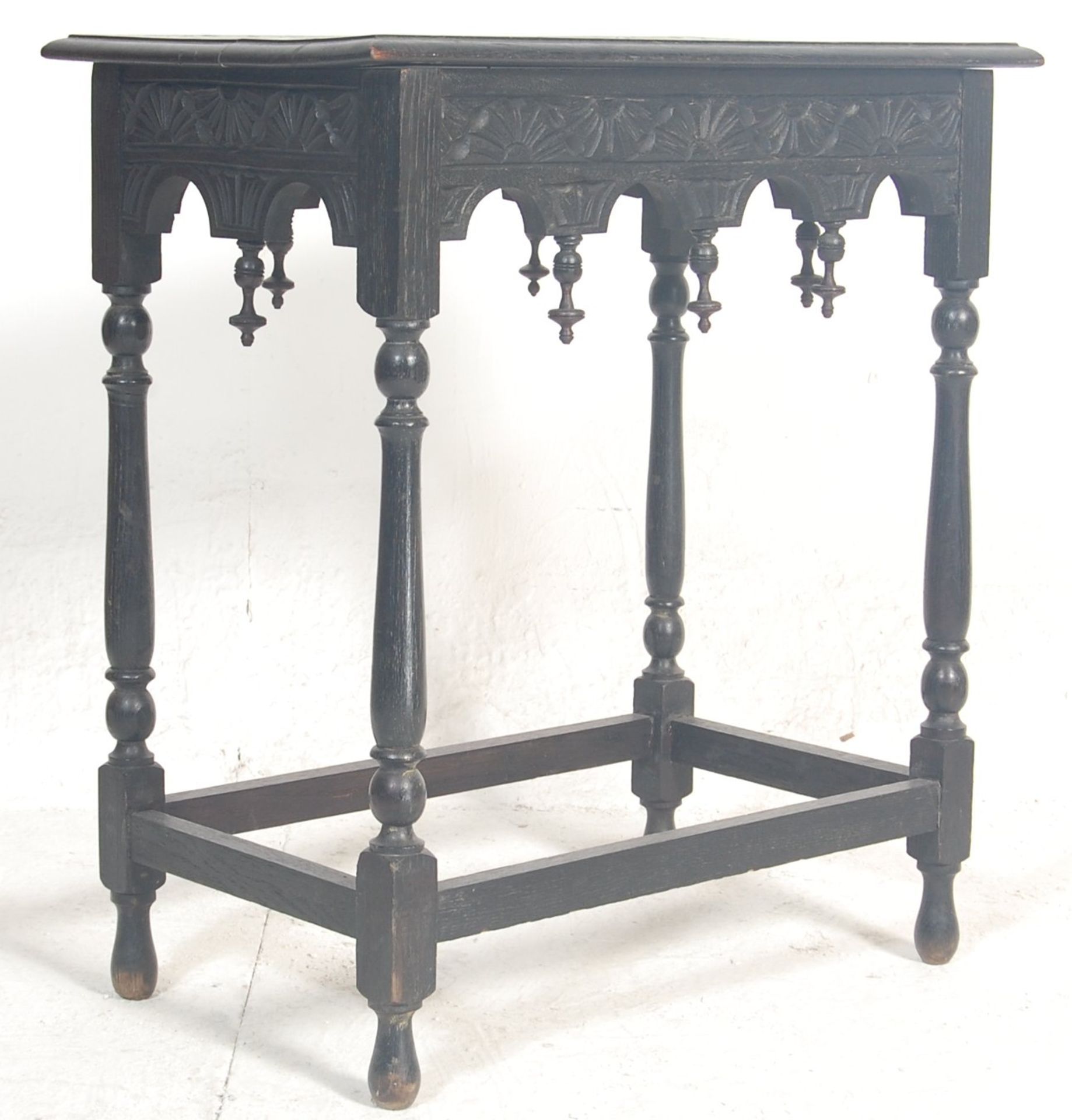 A 19th Century Victorian oak occasional / side table having a carved tabletop on a flared