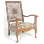 A 1930's Art Deco walnut bergere cane worked fireside armchair. Raised on cabriole legs with pad
