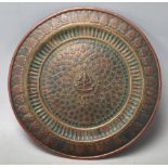 A late 19th century early 20th century Southern Indian bronze charger with central decoration of a