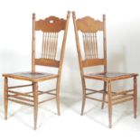 A pair of early 20th century American Arts & Crafts oak dining chairs. Each raised on turned legs