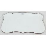 A 1920’s vintage wall hanging mirror in a shape of a shield with beveled glass mirror, oak back