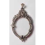 A late 19th / early 20th Century silver pendant locket of oval form having a frame set with round