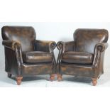 A pair of Antique style leather club - Chesterfield armchairs. Raised on turned legs with leather