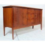 A vintage mid 20th century teakwood sideboard with oversized shaped top, bank of three drawers to