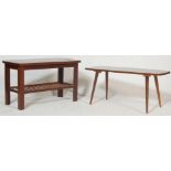 A pair of retro vintage 1970s teak wood coffee tables. One table having a surfboard shaped top