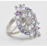 A large 925 silver CZ dress ring with multicolour stones set in a floral arrangement. Size P,