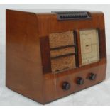 A 1920's EKCO Type P.B.510 walnut valve radio having a large glass dial to the right, front