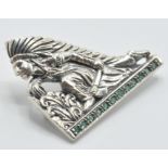 A stamped sterling silver brooch in the form of a Native American fighter wearing a feather
