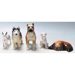 A collection of 20th Century ceramic figurines of dogs in various shapes and sizes to include a