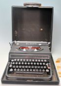 A vintage early 20th portable typewriter by Olivetti having articulated blank and chrome keys and is