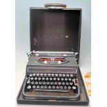 A vintage early 20th portable typewriter by Olivetti having articulated blank and chrome keys and is