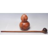 An early 20th century tribal hand carved Knobkerrie weapon along with a double gourd vase with