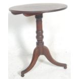 A Victorian 19th century mahogany tilt top wine / occasional table being raised on splayed leg