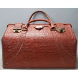 A good retro vintage 20th century large crocodile faux leather valise having brass lock, twin