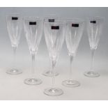 A SET OF SIX BOXED CRYSTAL CHAMPAGNE GLASSES