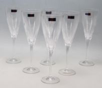 A SET OF SIX BOXED CRYSTAL CHAMPAGNE GLASSES