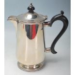 An early 20th century, 1912 silver coffee pot of cylindrical form with sparrow-beak spout, ebony