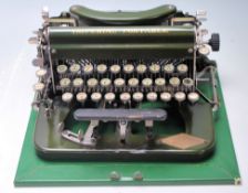 An vintage early 20th century typewriter by Imperial having a green enamel colourway with gilt