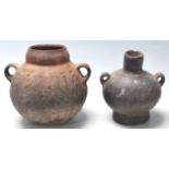A pre Columbian South American gourd shaped twin handled pottery / vase / drinking vessel having