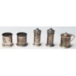 A group of four silver hallmarked cruets to include two pepperettes, two salt cellars and a lidded