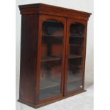 A Victorian 19th century mahogany library bookcase cabinet. Raised on a plinth banded base with