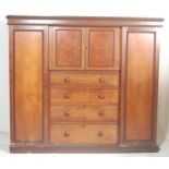 A Victorian 19th century mahogany triple wardrobe compact. Raised on a plinth base with twin