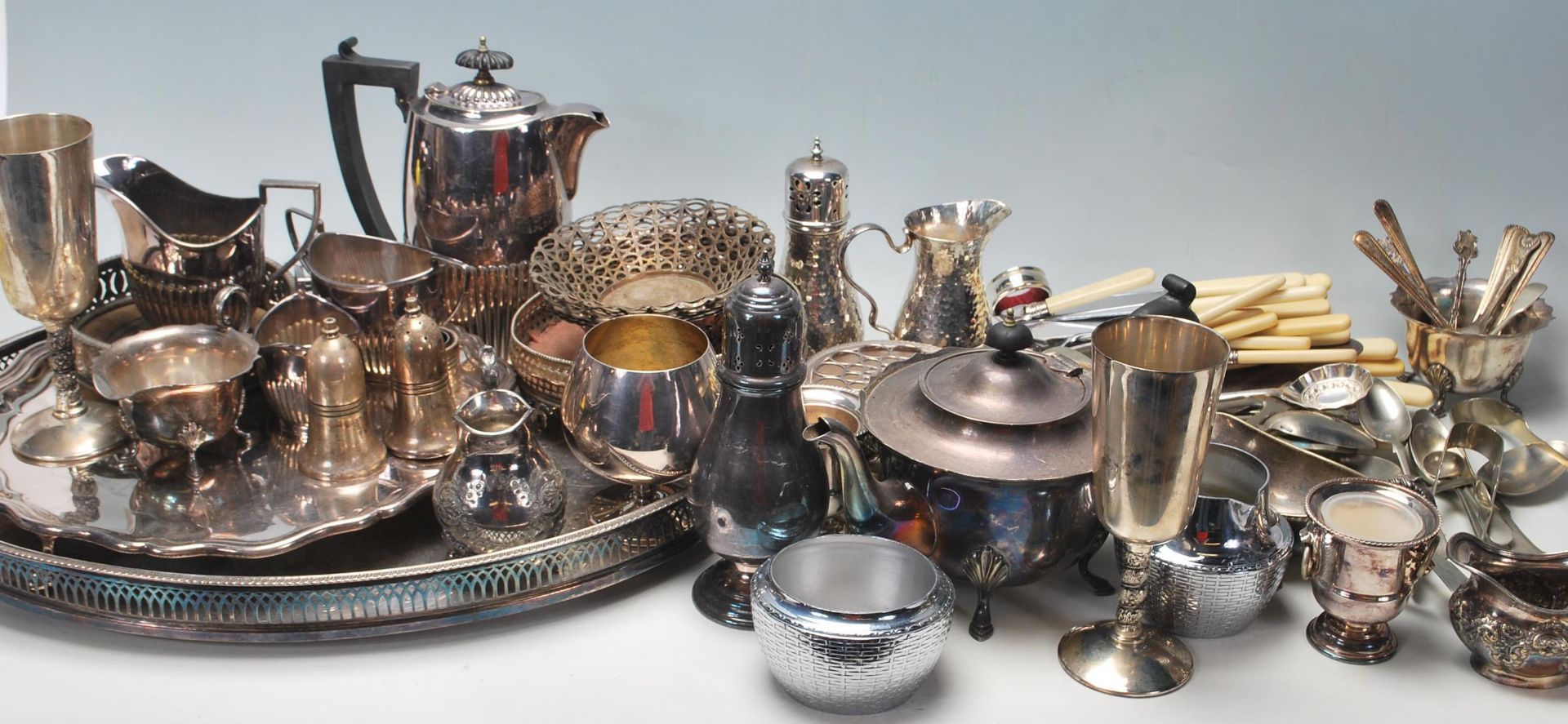 A large collection of assorted silver plate / silver plated wares to include flatware, gallery tray,
