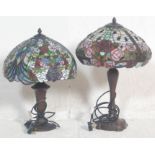 A matched pair of 20th century Tiffany style table lamps, each with shaped columns on circular