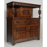 A 20th century Jacobean revival oak court cupboard in the manner of Jaycee / Old Charm Wood Bros.