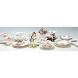 A collection of vintage early 20th Century fine bone china tea cups, trios and flower posies by