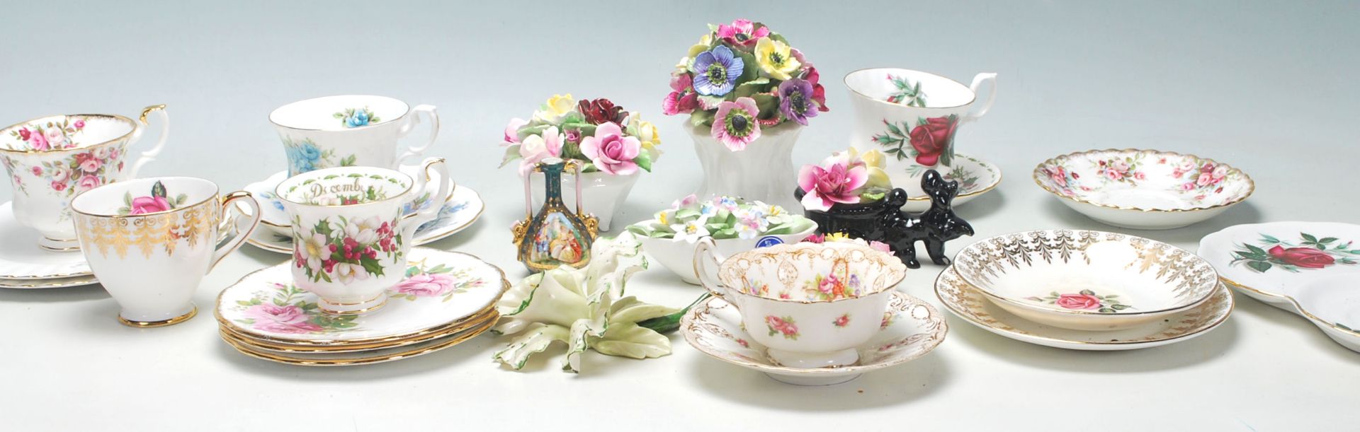 A collection of vintage early 20th Century fine bone china tea cups, trios and flower posies by