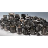 A large collection of pewter tankards dating from the 19th century to include many examples,
