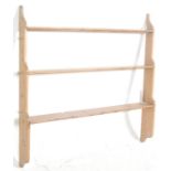 A Victorian 19th century country pine delft rack of shaped construction being wall mounted with