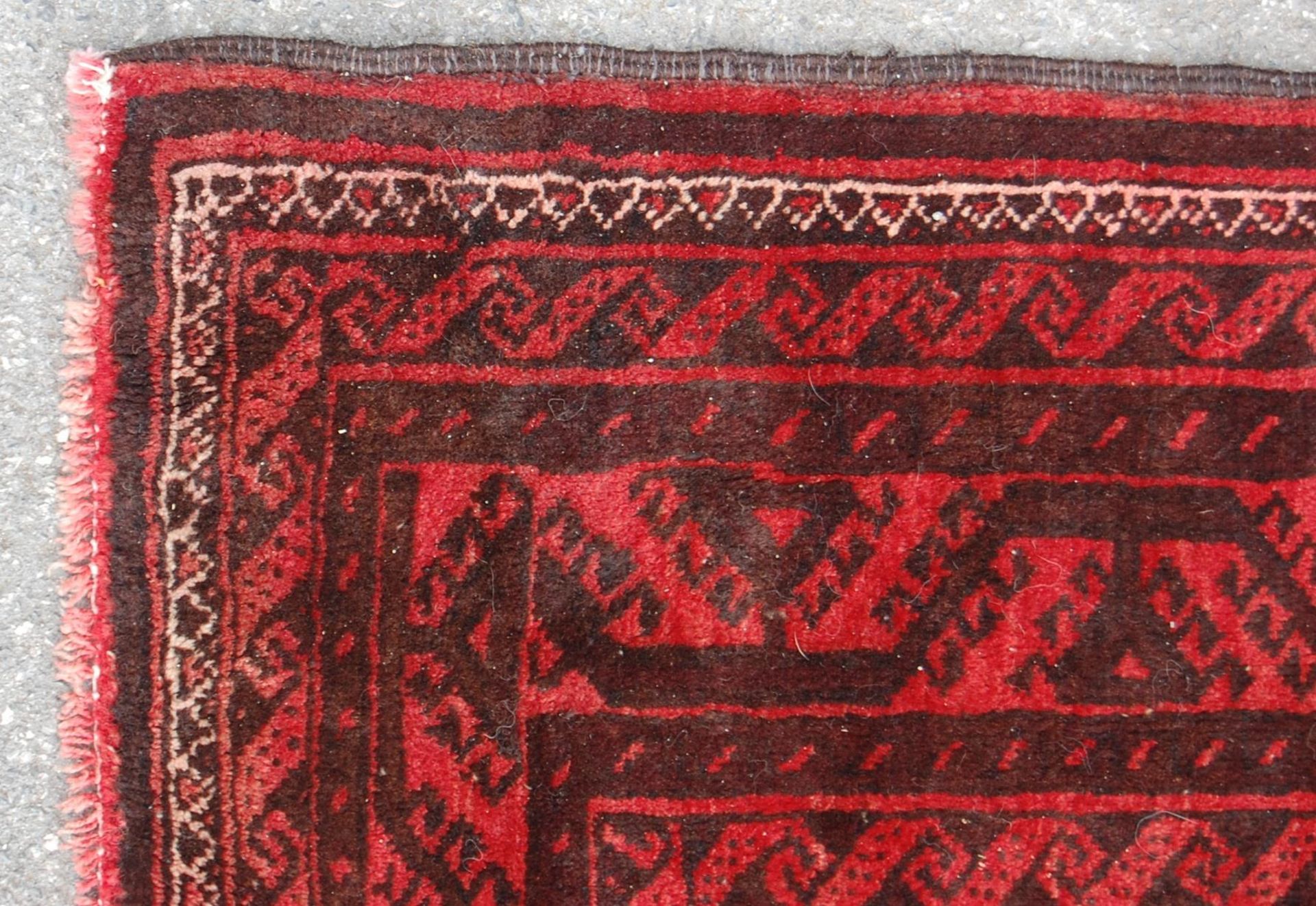 A pair of Islamic / Persian carpet rugs comprising of a red and black carpet having three - Image 8 of 9
