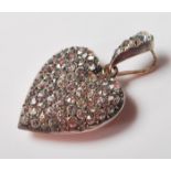 A 20th Century silver and paste stone set pendant in the form of a heart having a paste set bale and