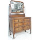 A 1920's Jacobean revival oak dressing table chest. Raised on barley twist legs with a series of
