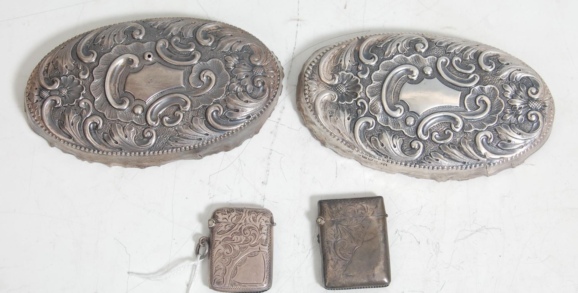 A pair of silver hallmark vesta cases having engraving decorations to the body, hinged lid,