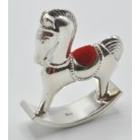 A stamped sterling silver 925 pincushion in the form of a rocking horse with velvet cushion to the