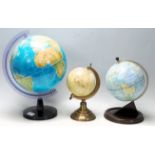 A group of three retro vintage 20th Century desktop globes to include a mid Century globe raised