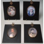 A group of four silhouette frames each having square ebonised wooden panels with central oval frames