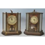 Two vintage late 20th Century glass cased anniversary clocks of hexagonal form both raised on