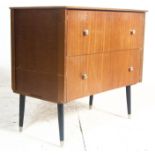 A vintage mid century teak wood chest of drawers. The chest being raised on eboniesed dinette legs w