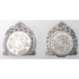 An antique belt buckle having two 19th Century silver coins moulded to the front panel and decorated