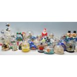 A large collection of original vintage collectable plastic snow globes from around the world to