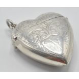 A sterling silver vesta case in the form of a heart with having a chased decoration. Marked