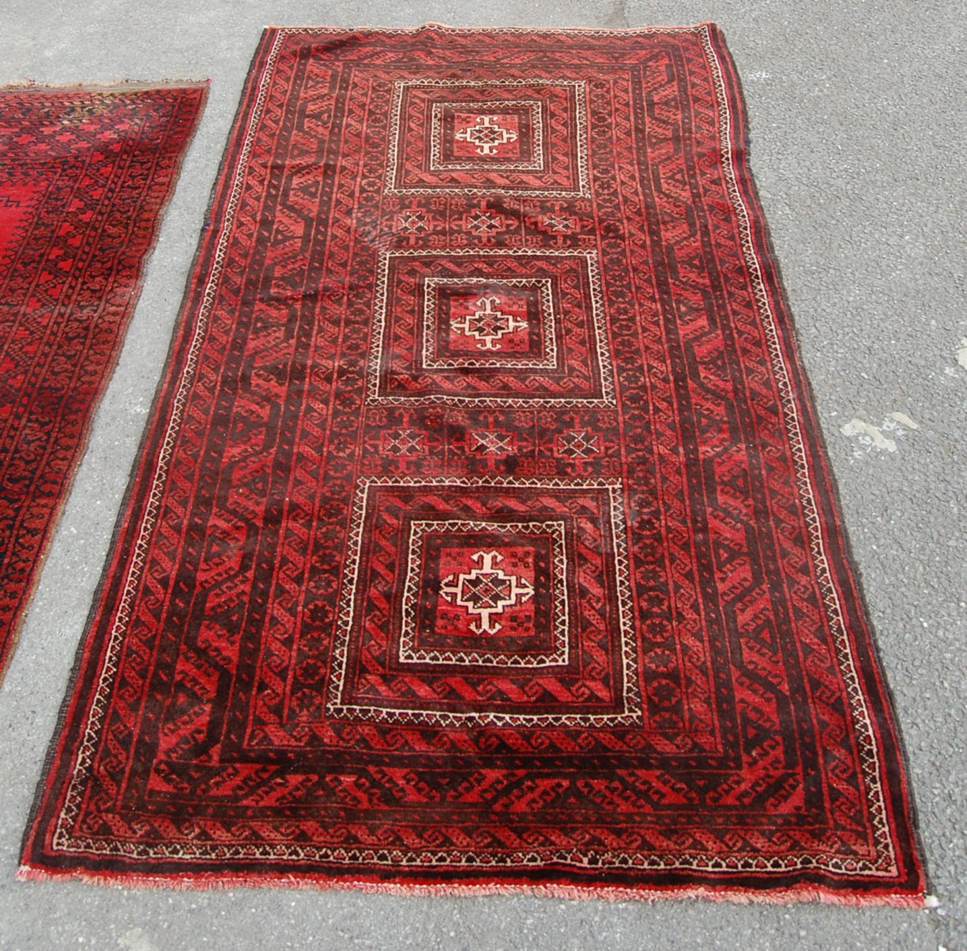 A pair of Islamic / Persian carpet rugs comprising of a red and black carpet having three - Image 6 of 9