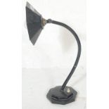 A 1920's cast metal and ebonised Industrial desk / table lamp. Raised on black octagonal base with