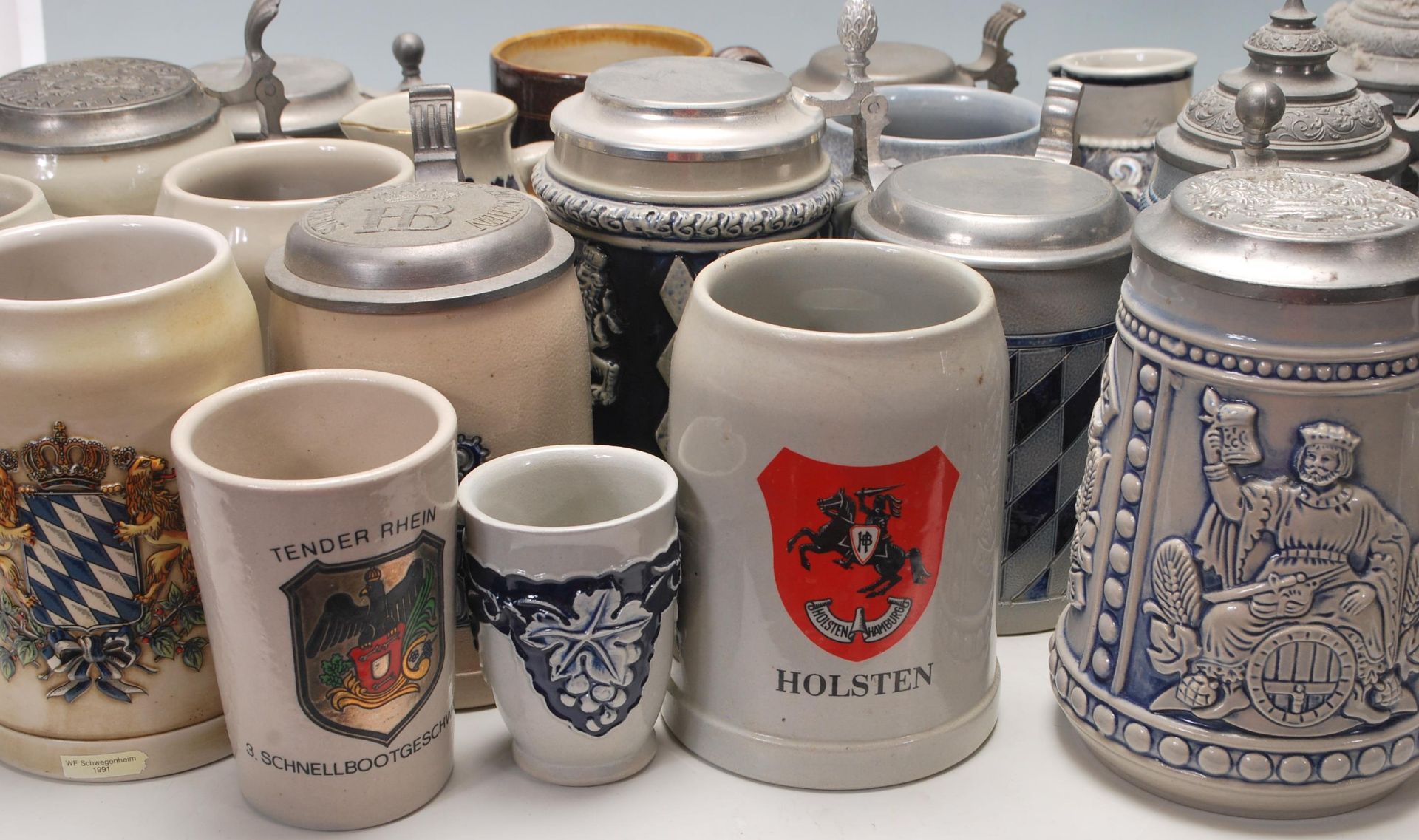 A collection of 20th Century German ceramic stein drinking glasses, each having raised decoration to - Bild 3 aus 10