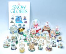 A large collection of 25+ original vintage collectable glass and plastic snow globes to include, The